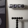 Karlsson Wandklok Tube Flip zilver