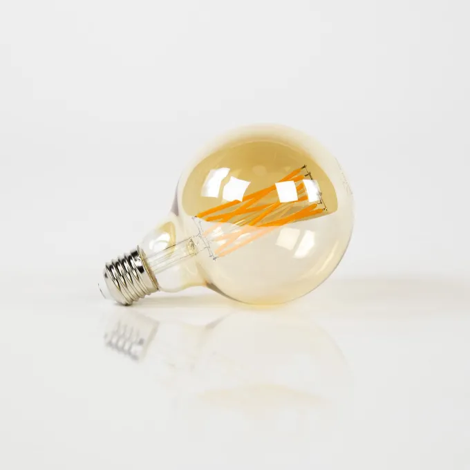 WoonStijl Lichtbron LED filament bol Ø9 5 - E27 6W dimbaar / Amberkleurig glas